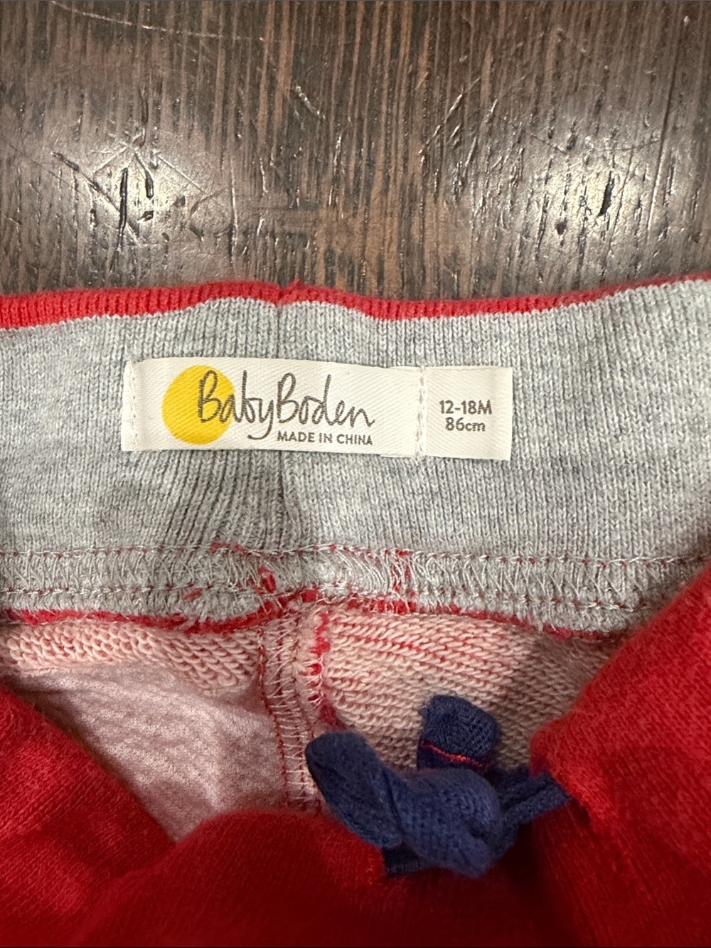 Baby Boden Red Jogger Pants with Blue Striped Cuffs and Star Detail on Backside - Picture 2 of 7